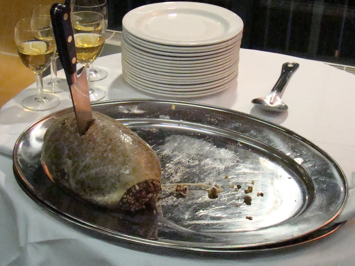 A haggis on a platter with a knife, set for a formal address before serving